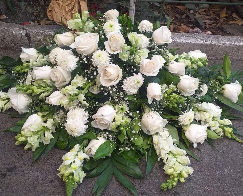 An image of white roses in an arrangement outside